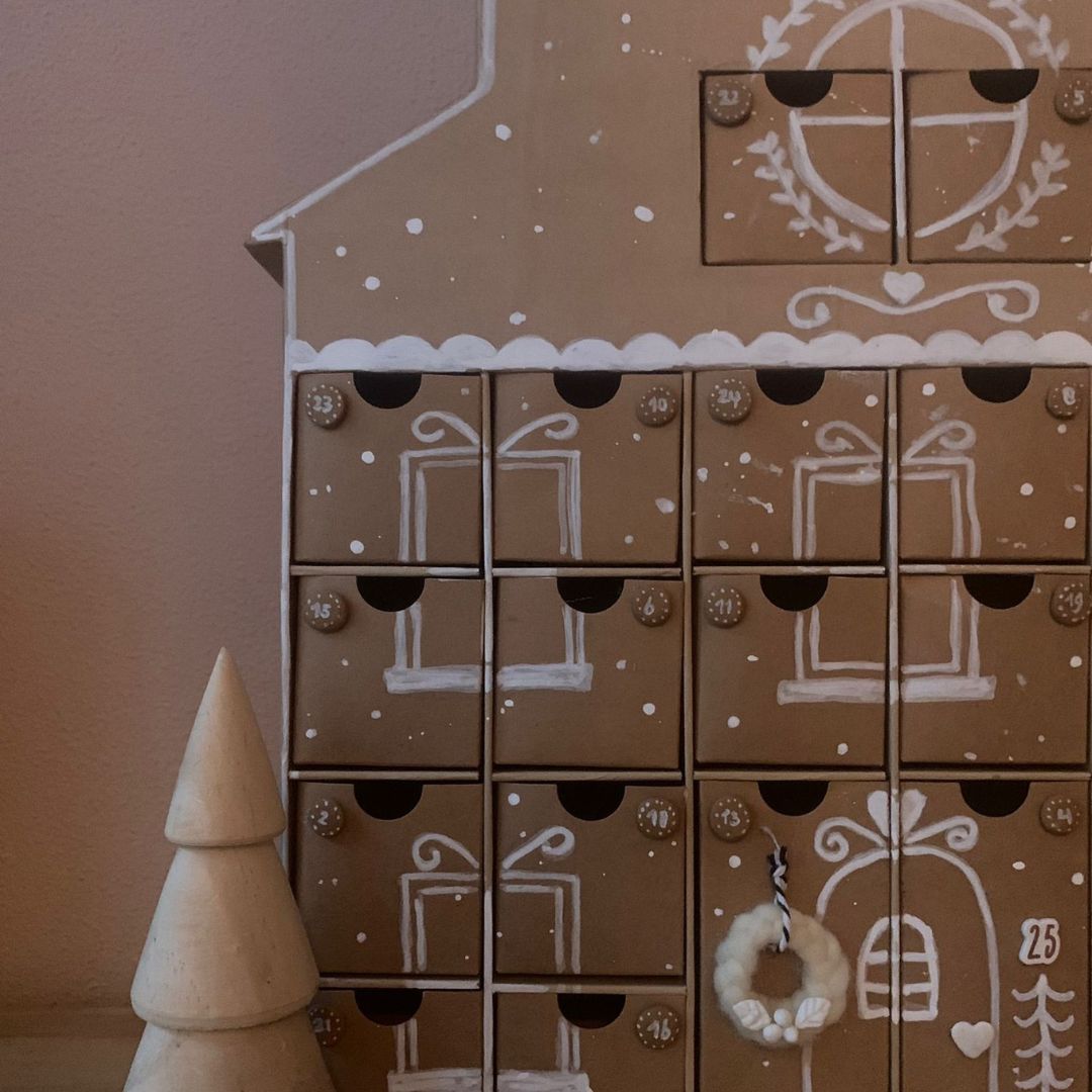 Advent Huis DIY project beschildert met witte stiften, aftellen tot de kerst.